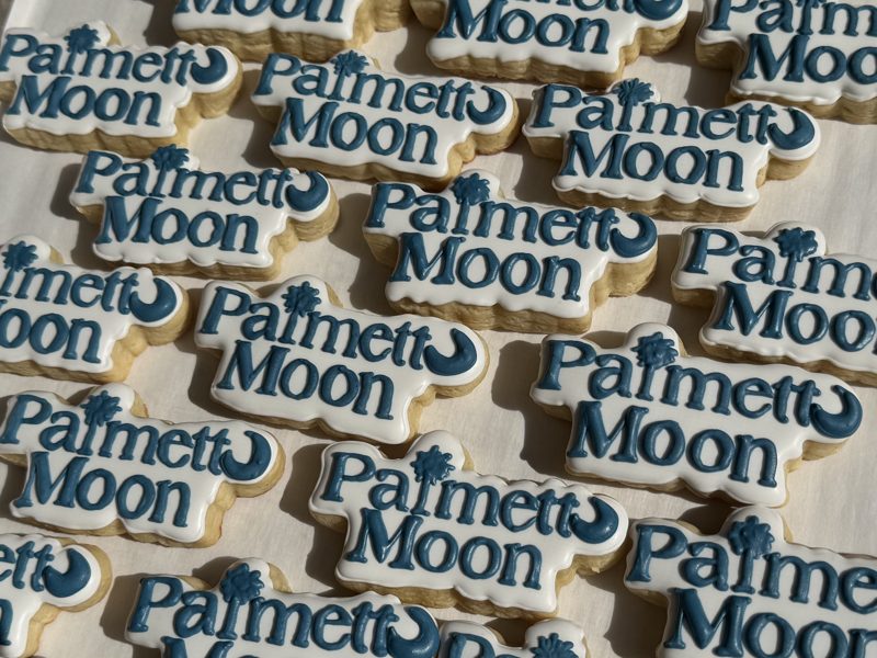 Example: Palmetto Moon logo cookies piped in navy on white
